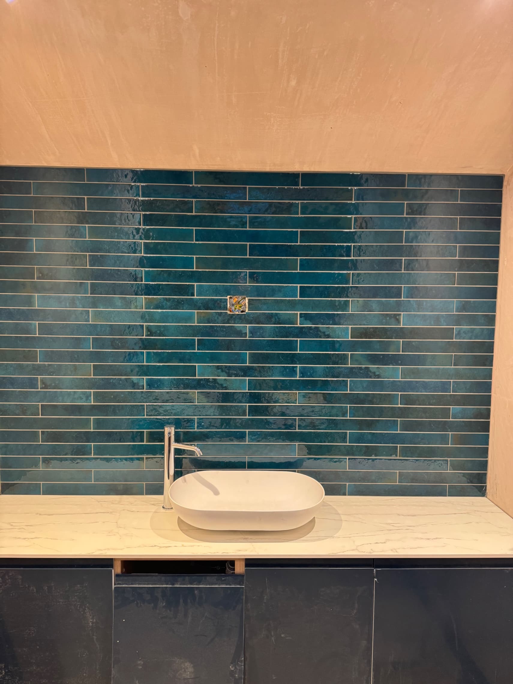 We've finished the splashback tiling behind the basin using the same beautiful teal metro tiles as the bath surround, bringing the whole bathroom together nicely.