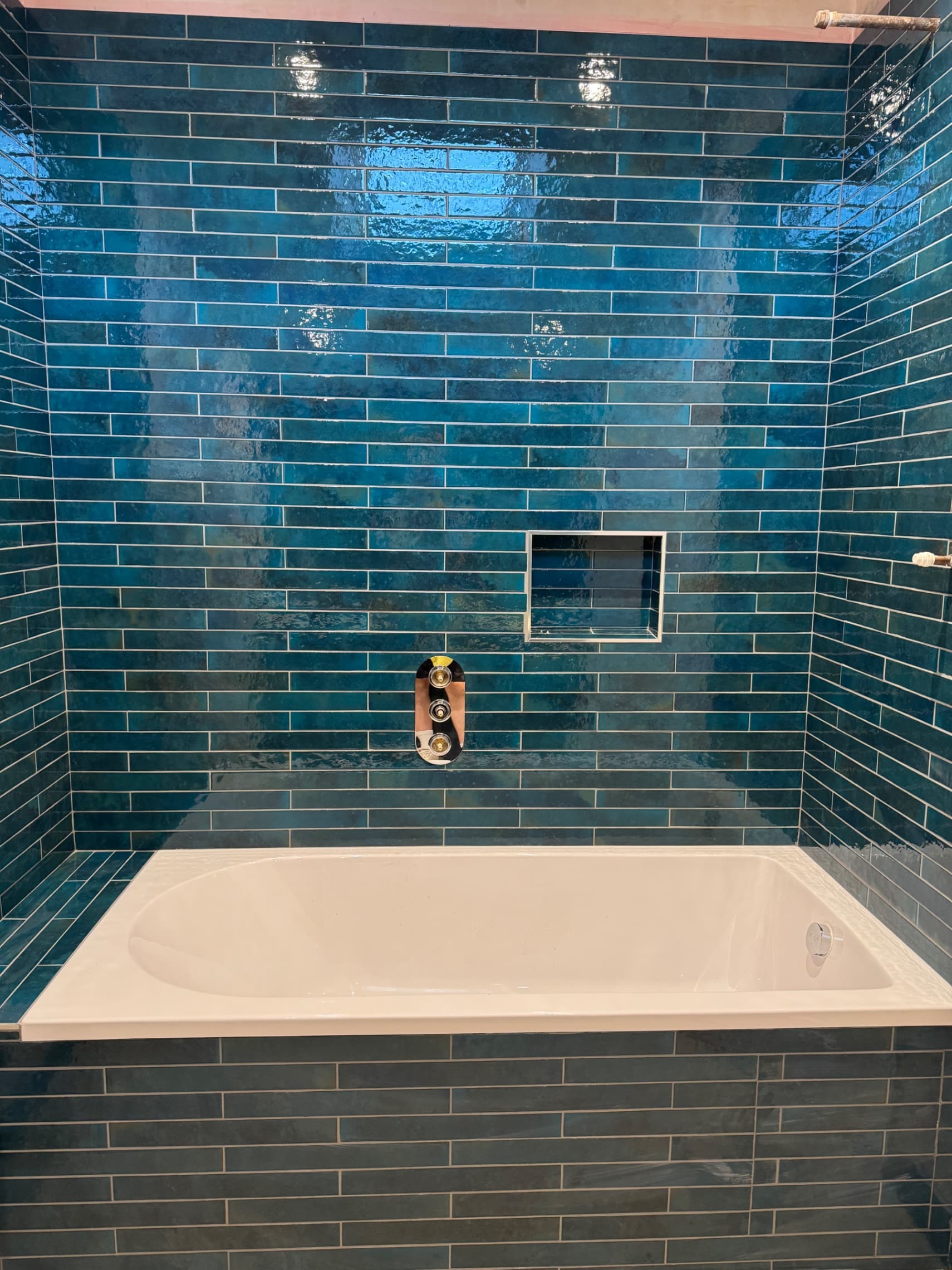 We've tiled this bathroom in Twyford with beautiful teal metro tiles across all the walls, creating a real feature with the natural colour variation in the glaze.
