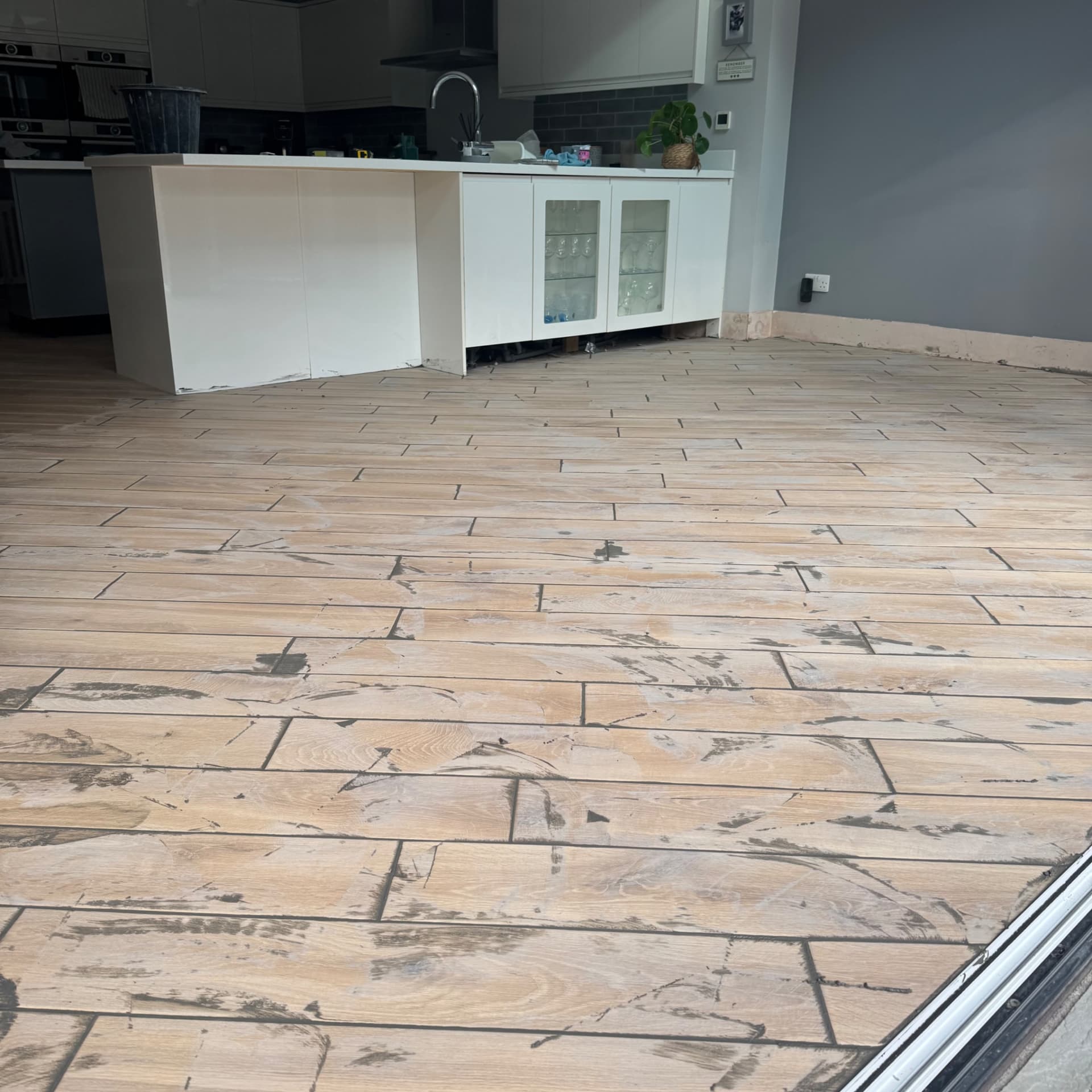We're getting the grout in now, and there's plenty of joints to fill with this diagonal layout. We're using a grey Mapei grout which will dry considerably lighter than it looks when it's freshly applied, so the final finish will be a bit brighter than what you see here.