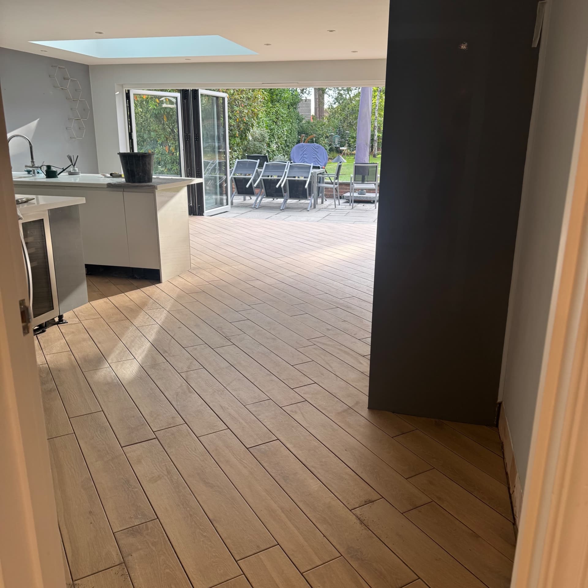 We've finished laying the tiles throughout this open plan space and we're really pleased with how the diagonal pattern works in the room. The wood-effect tiles flow beautifully from the kitchen through to the hallway and downstairs bathroom, and we'll be sharing more photos soon to show you the different areas we've completed.